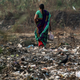An Indian woman holds a bucket as she goes to use a latrine in the open, on World Toilet Day on the outskirts of Mumbai, India, 19 November 2014.